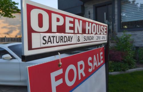 "For Sale" sign outside of a house.