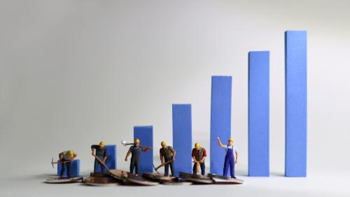 Worker figurines with piles of coins in front of a bar graph.